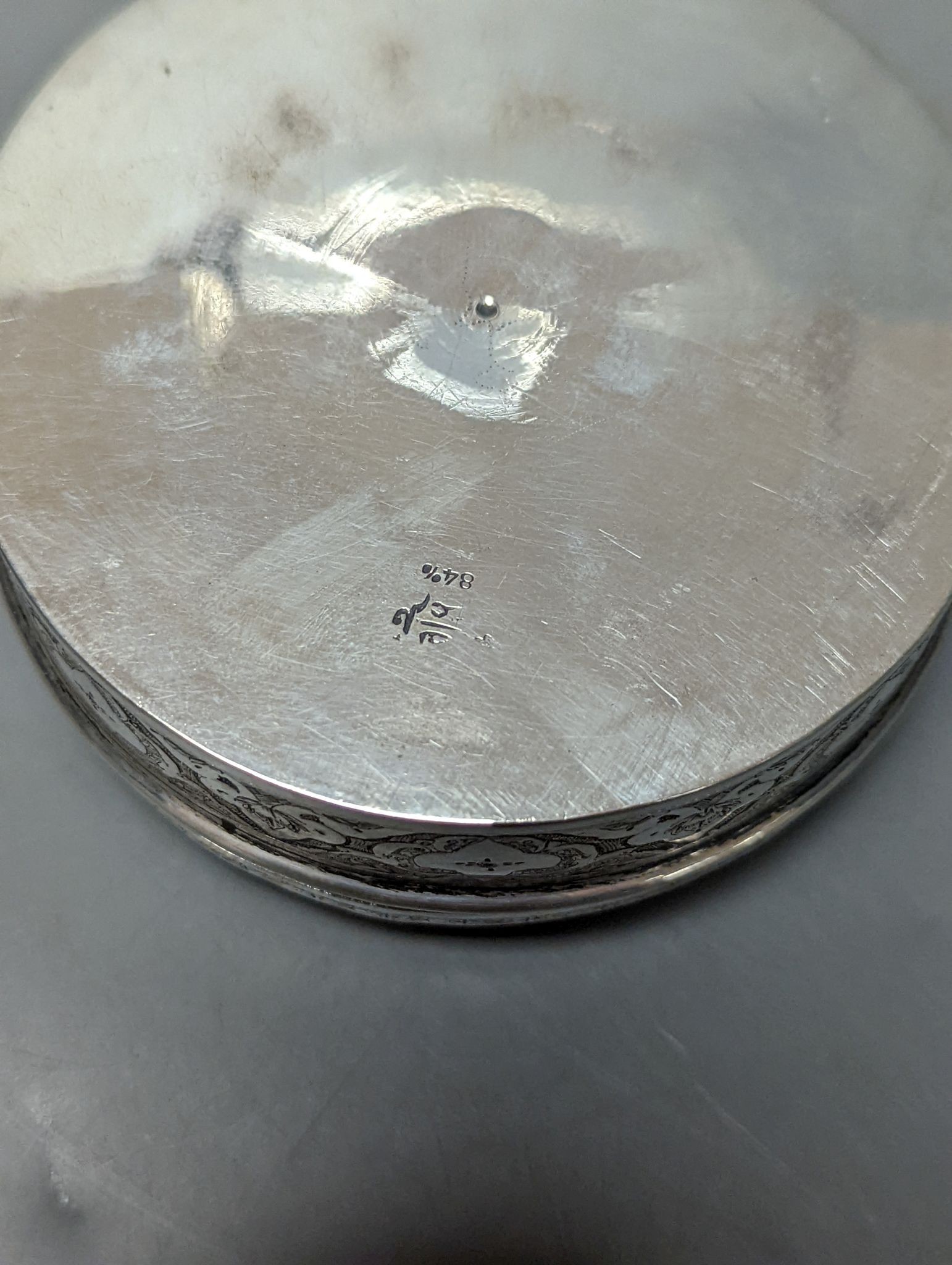 A Persian engraved white metal circular box and cover, 86mm